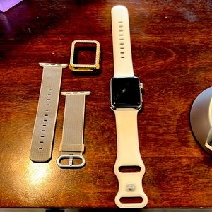 Apple Watch Series 1 38M with extra watch band and gold bling watch face cover.